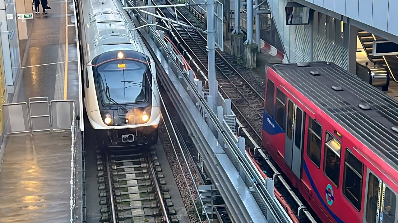 Elizabeth line and Docklands light railway trains at Custom House