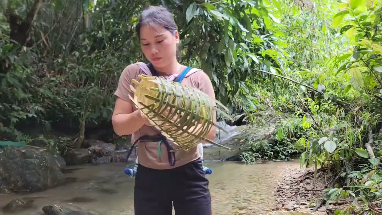 The girl weaves bamboo baskets for catching stream fish and harvests bamboo shoots - picks lemons.