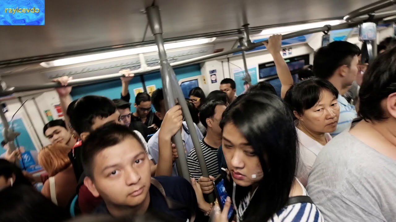 Asoke BTS Skytrain Station Sukhumvit Line commuters at rush hour