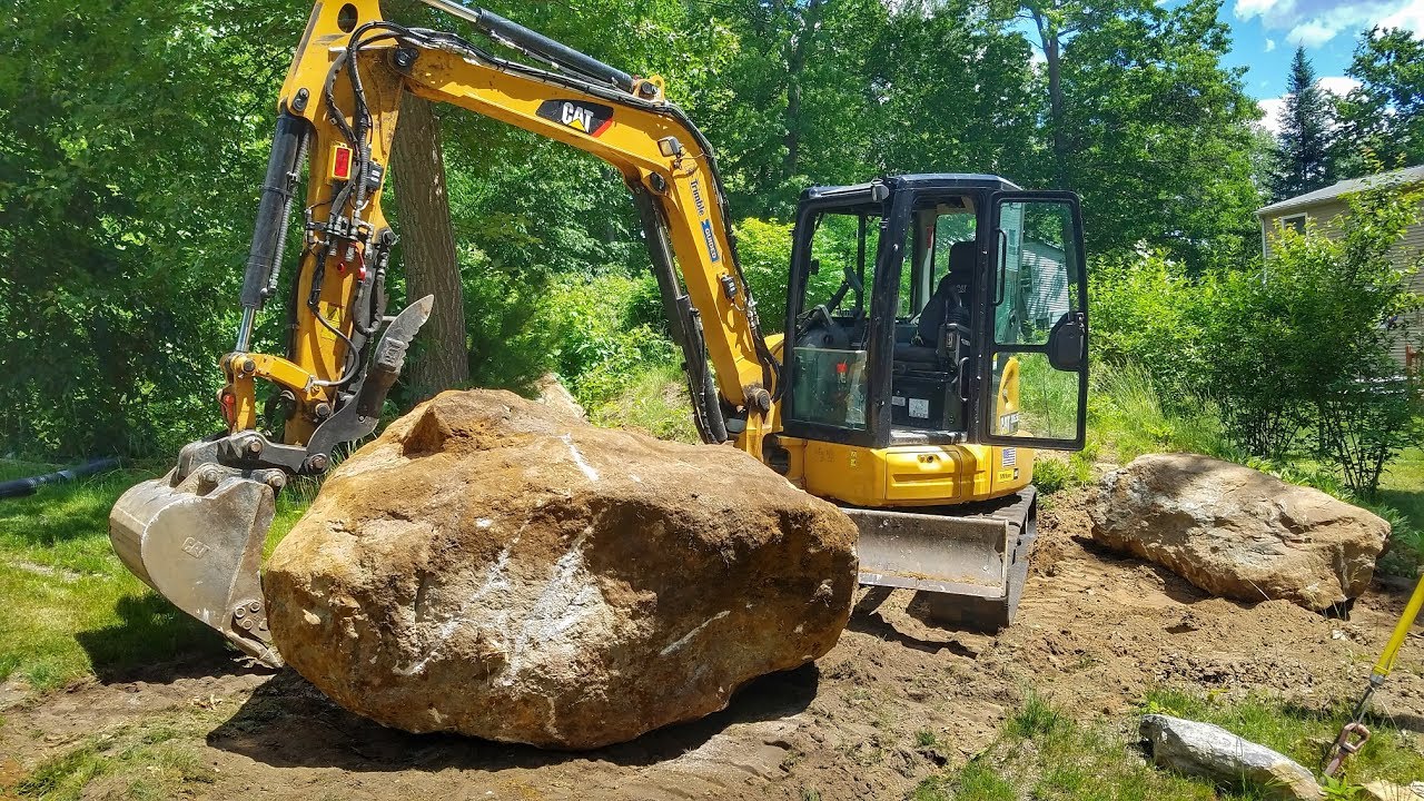 Caterpillar 305.5e2 Moving Large Boulder