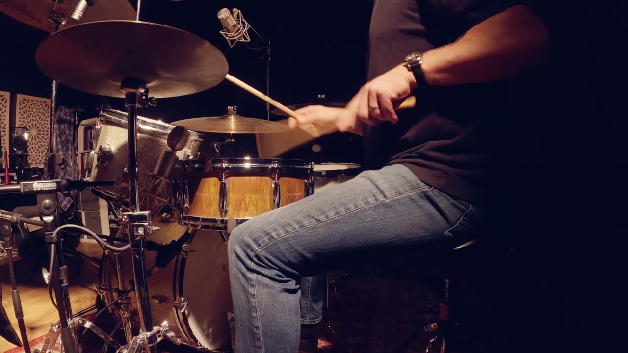 Using single stroke and roll drum rudiments 