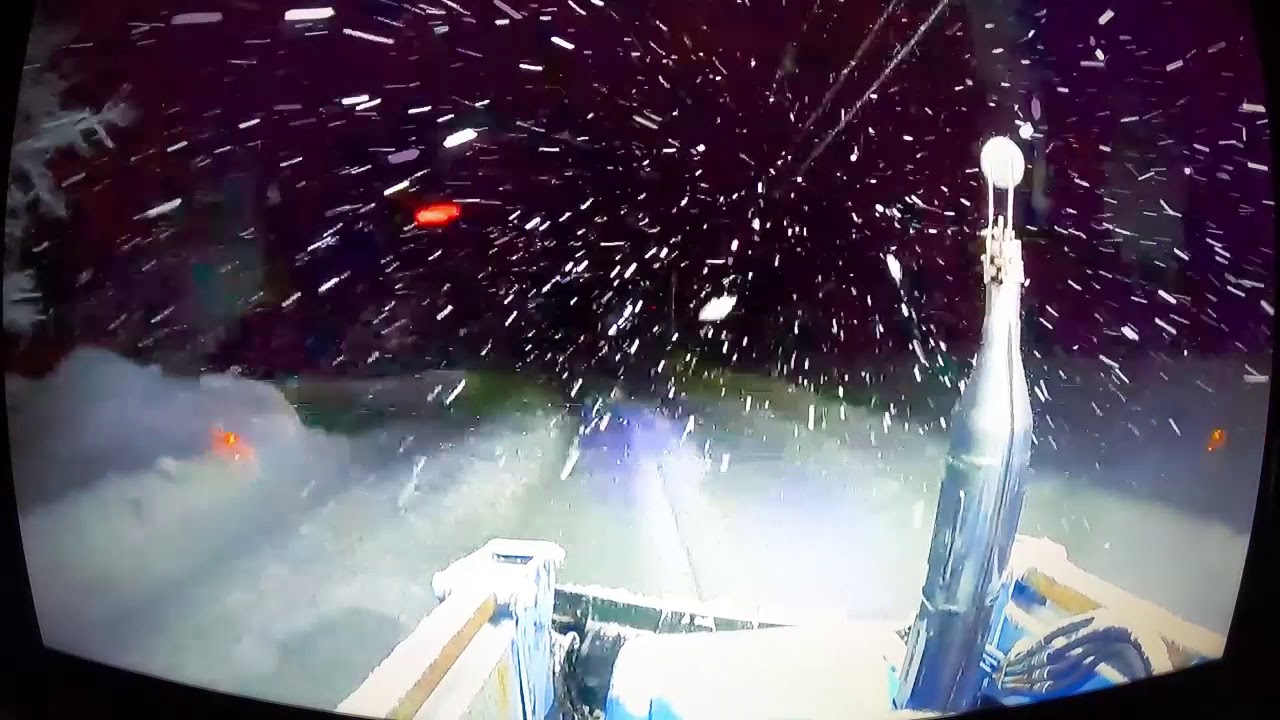 Canadian winter Storm, nighttime snow plowing of the private road