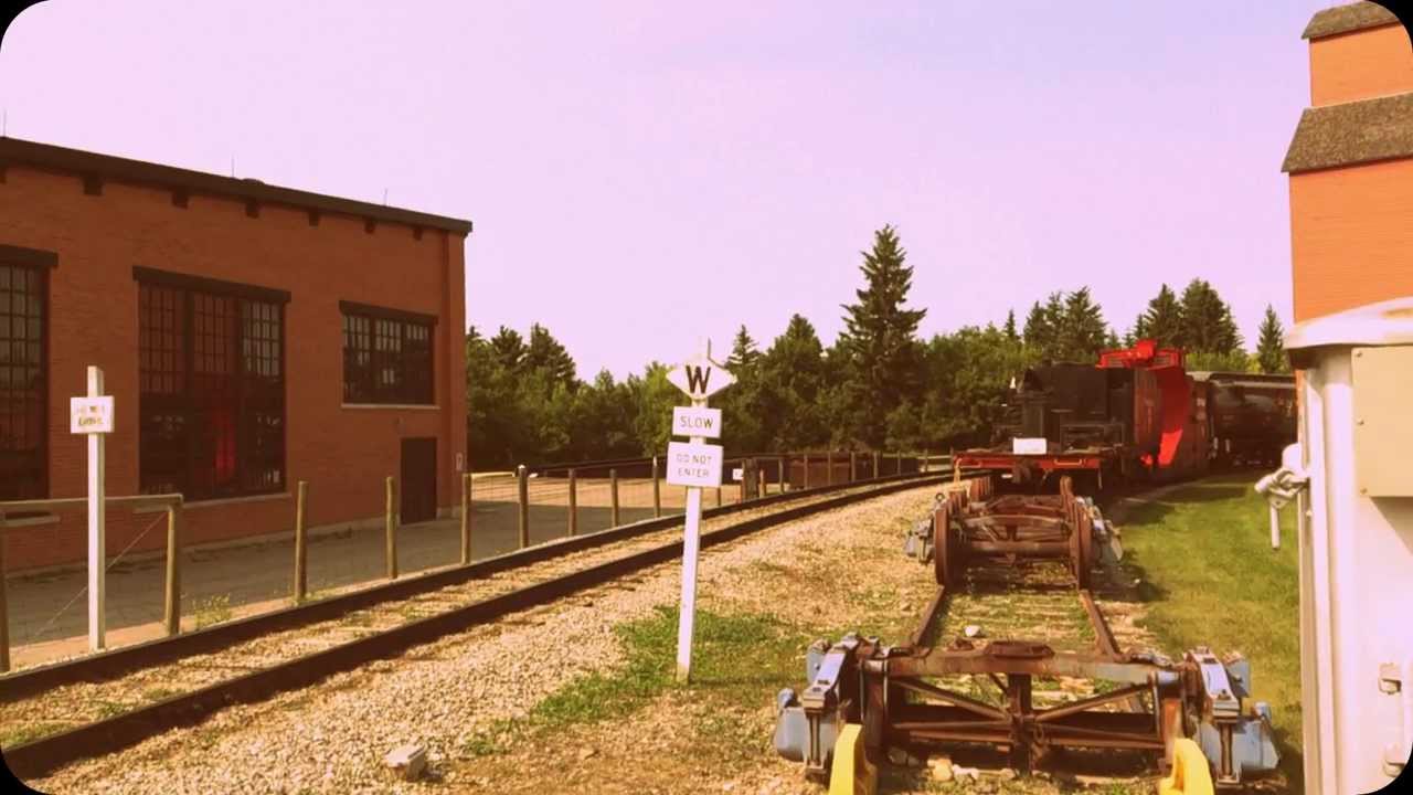 Steam Train Coming and Stopping at a Station