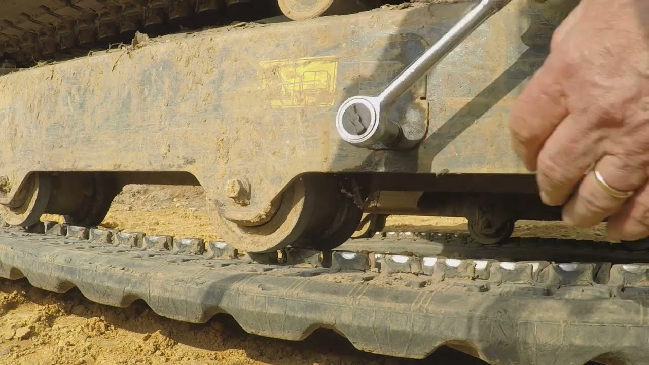 servicing Kubota U27 4 adjusting track tension