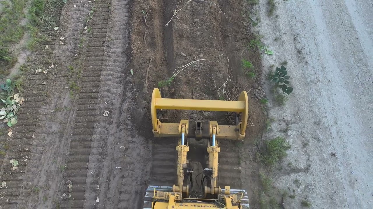 Root Plow pulled by D9H Caterpillar Dozer