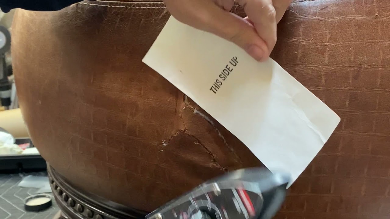 Ripped and Repaired Leather Ottoman