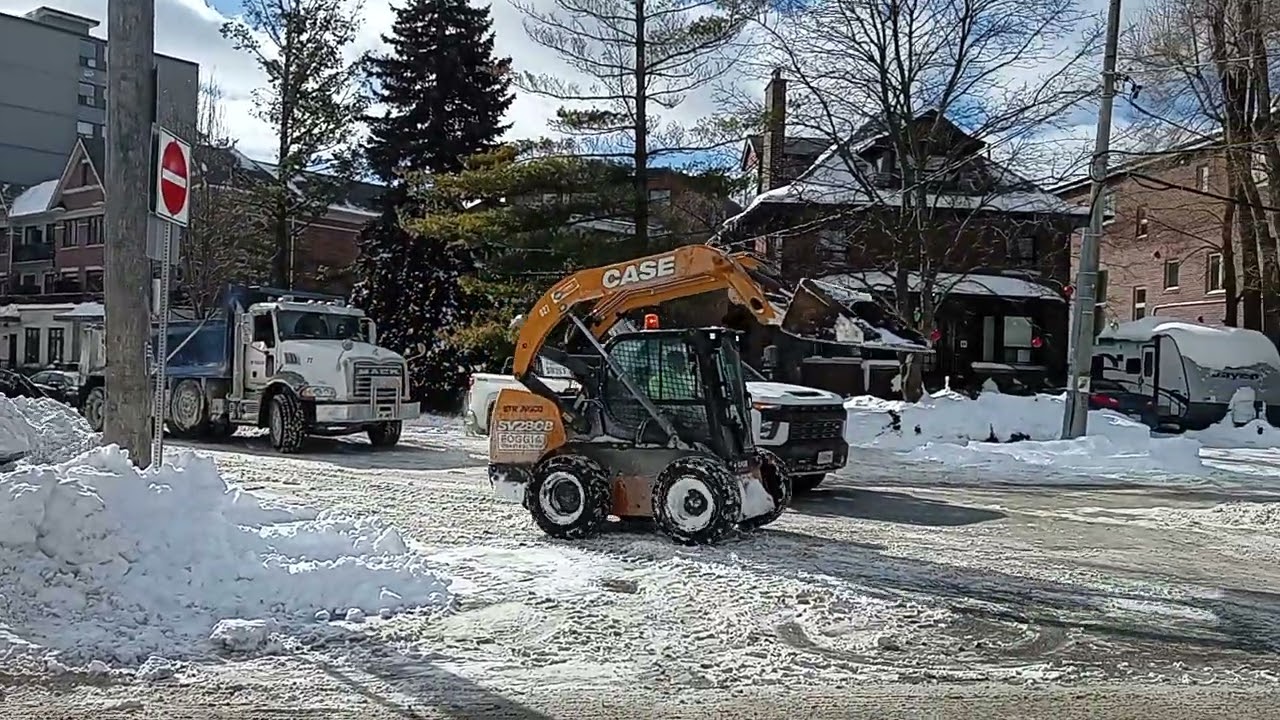 Major snow storm clean up side Streets Toronto Canada Heavy machinery equipment 