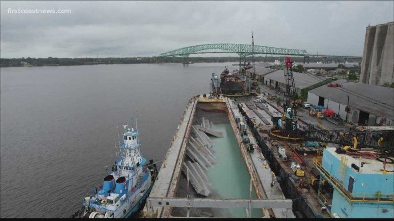 Pollution-laden barge removed after months of leaking coal ash arrives at final destination