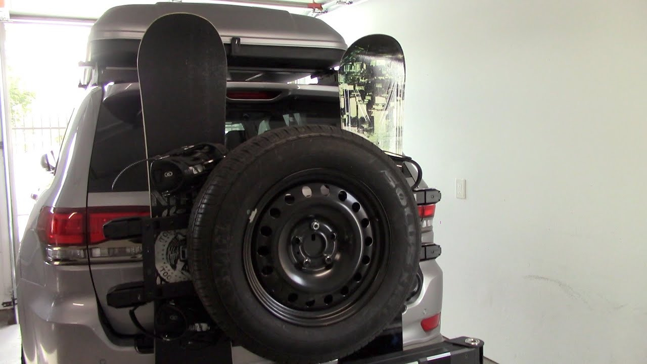 Custom spare tire and snowboard rack. Jeep Grand Cherokee. Kuat Pivot V2 hitch mount and Inno INA951