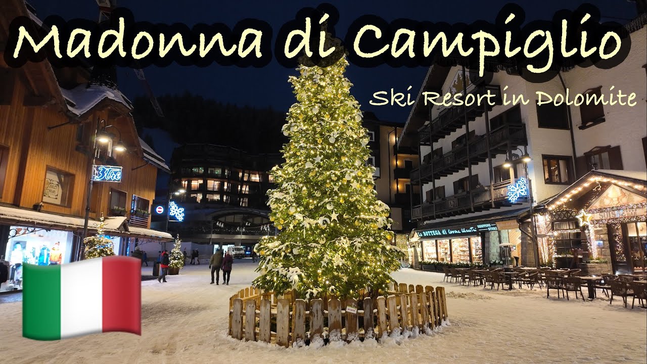 Madonna di Campiglio Ski resort in Dolomites Italy during white snow Christmas night walking tour