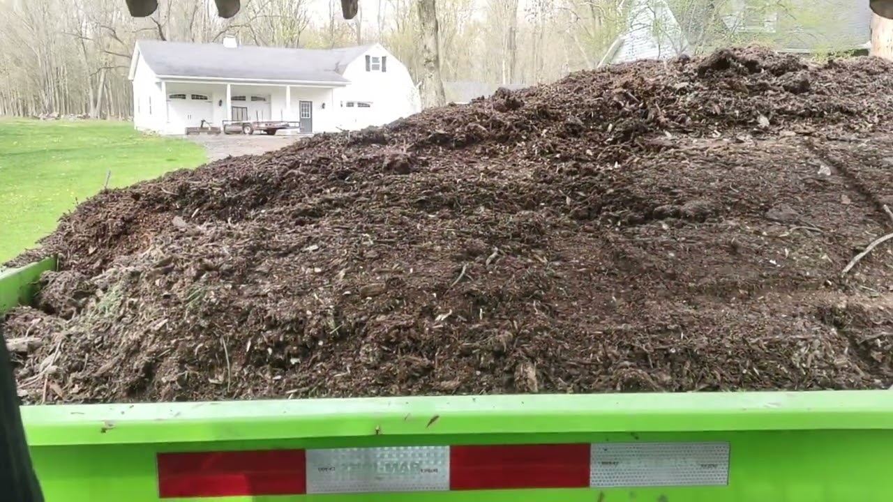 Cleaning up  stump grindings landscape job
