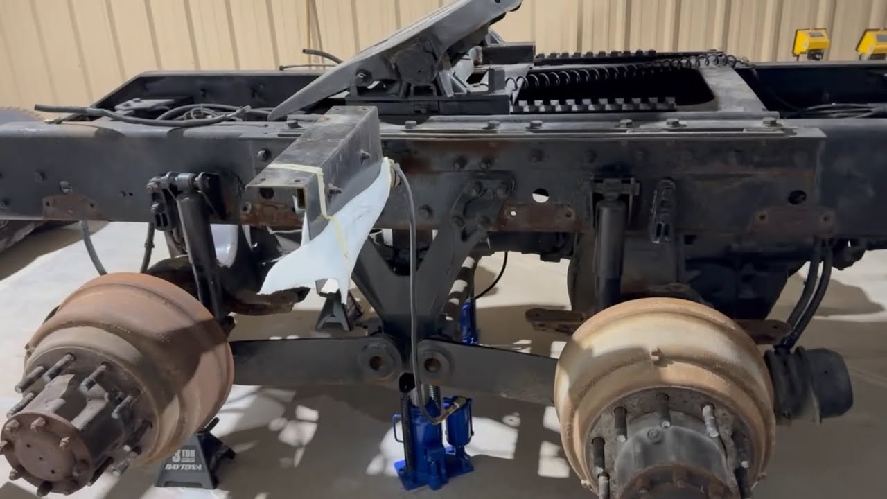 W900 and John Deere. Removing airbags, brackets, sleeper panels, and priming the skidsteer.