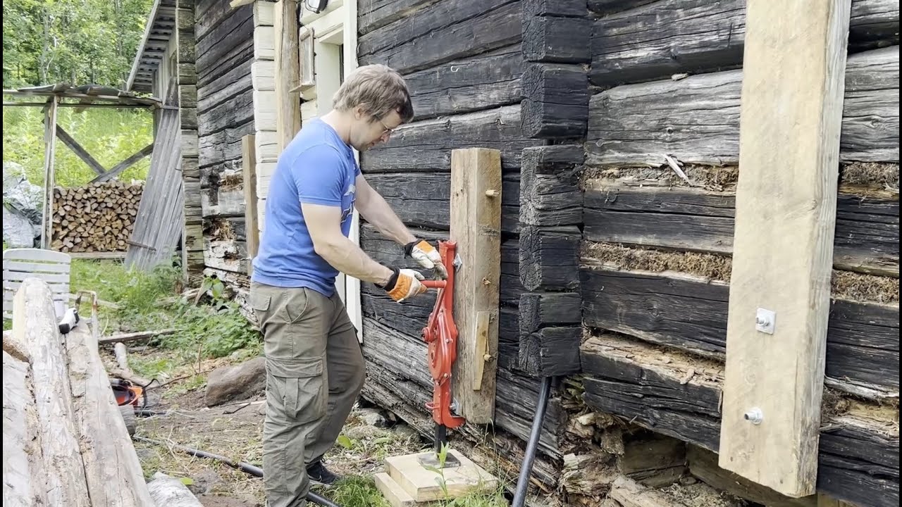 Repairing  long wall on a log house, replacing the bottom log