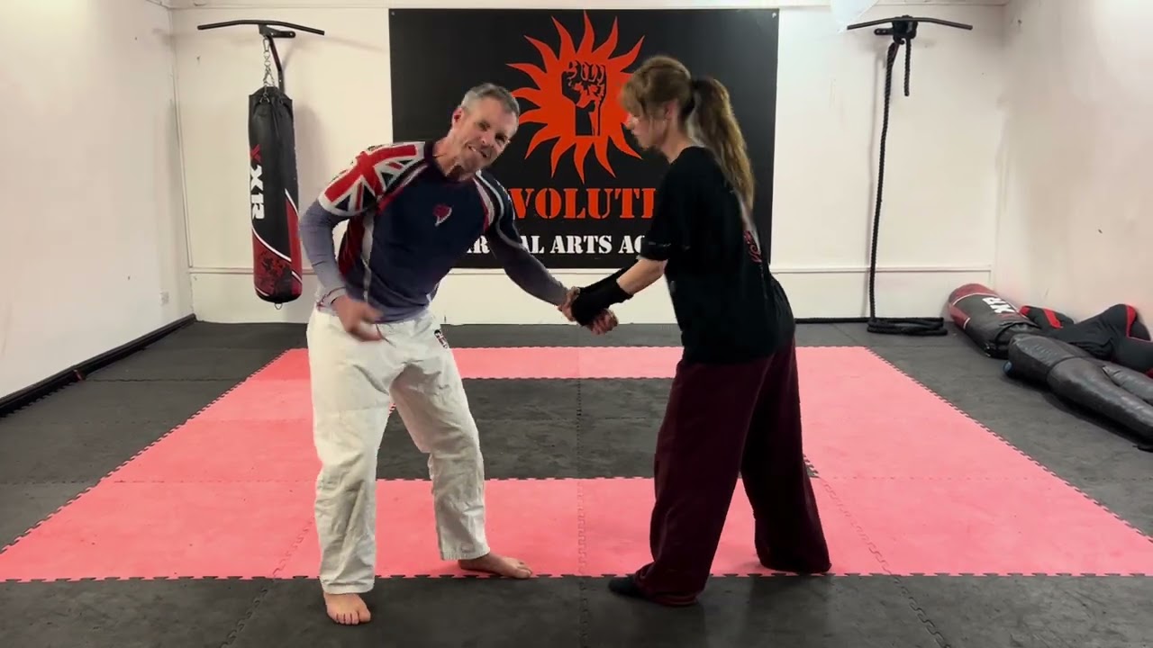 Defending a double hand wrist grab.