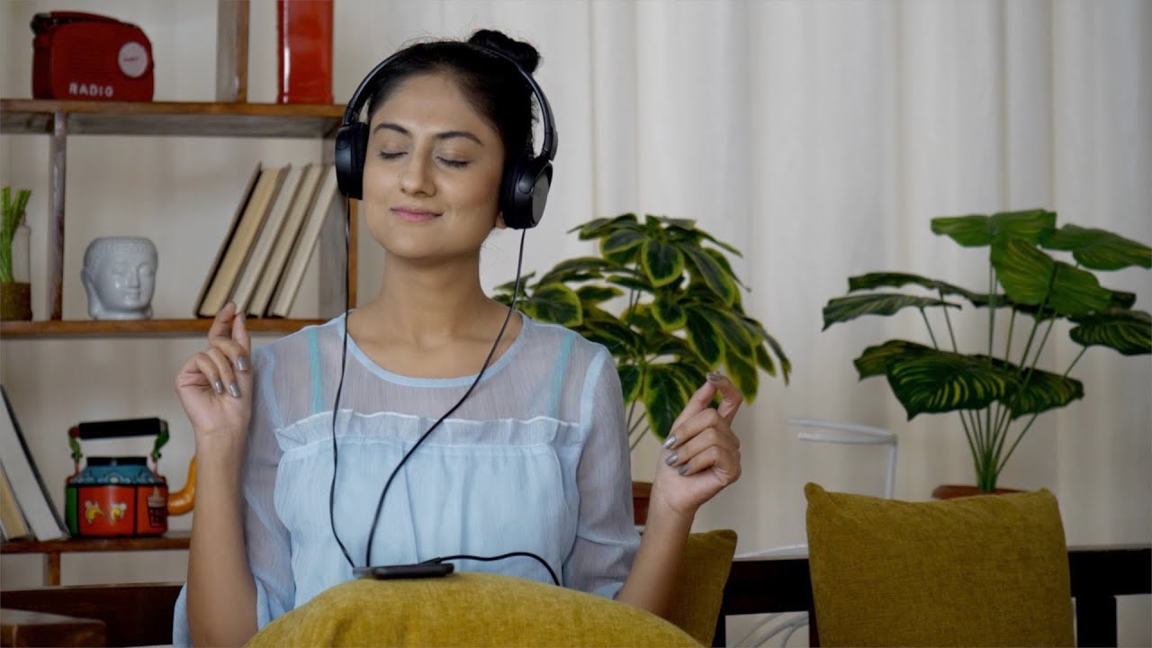 Cute teen girl wearing black headphones is listening to music ... | Indian Stock Footage | Knot9