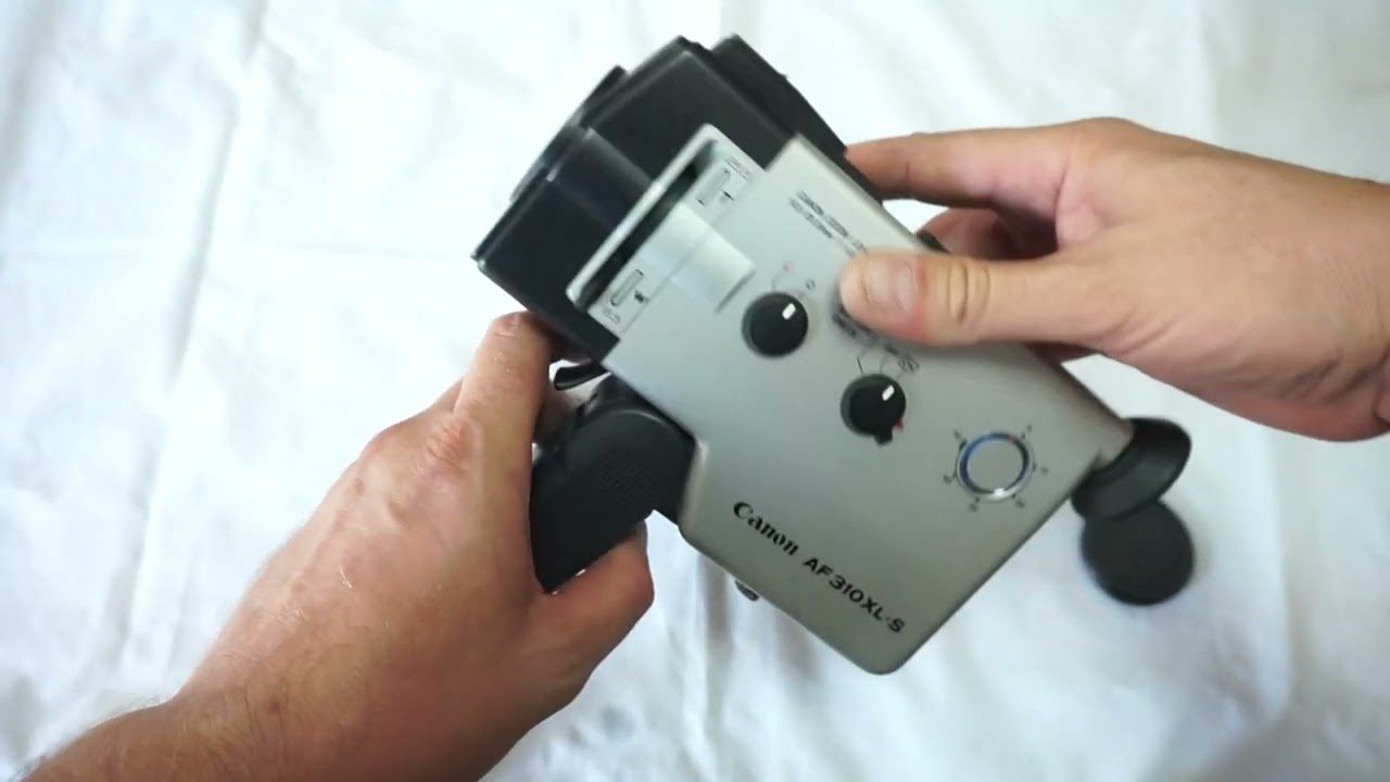 Canon AF 310 XL-S loading Super 8 film and batteries on Super 8 camera Canon AF 310 XL S