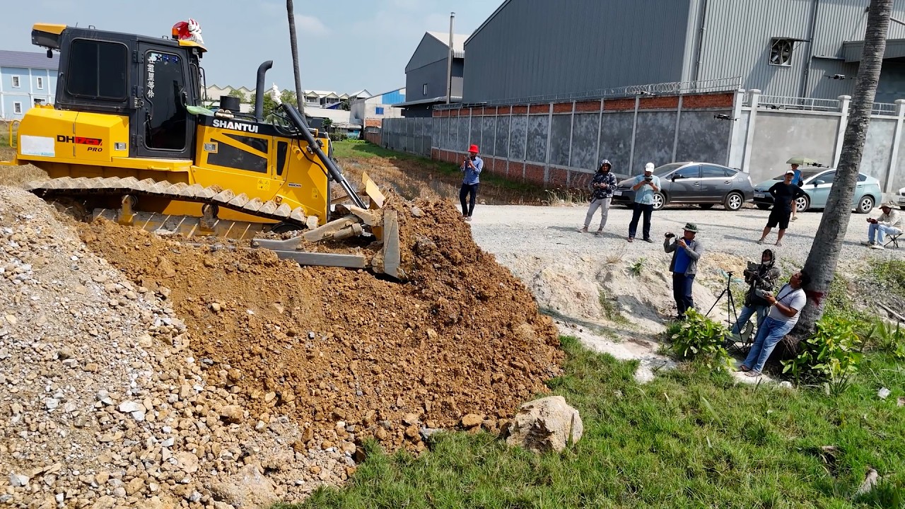 New landfill being built! dump truck and bulldozer are being used to push rock into the flooded land
