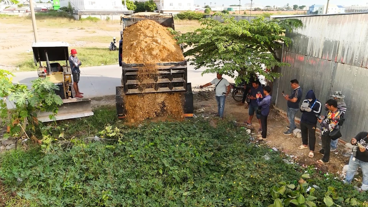 Start Nicely Landfill Task! Smart Bulldozer Driver Push Soils With Dump Trucks Dumping Into Low Land