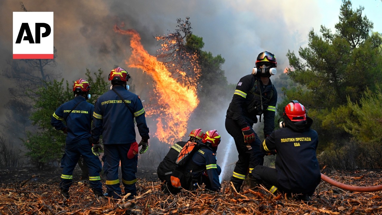 Firefighters battle a wind-driven wildfire in Porto Germeno, Greece