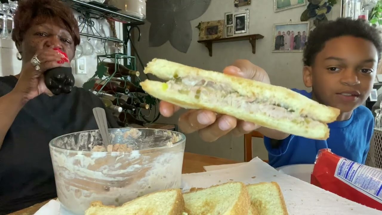 Eating homemade tuna, salad sandwiches
