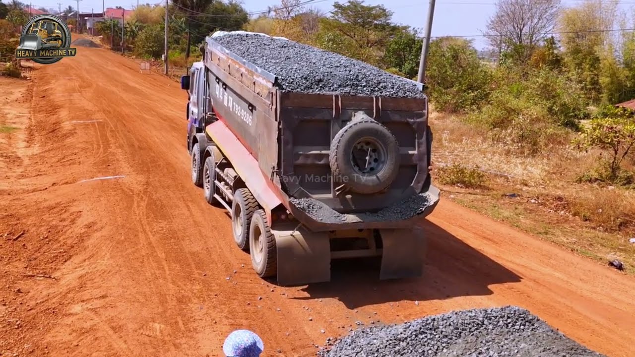 New Upgrade Gravel Laid Road Base Optimization by Skilled Bulldozer as Trucks Continuously Supply