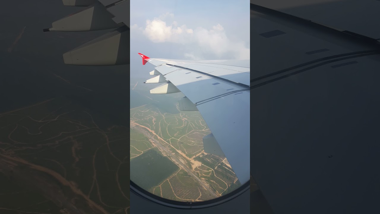 plane turning over green country