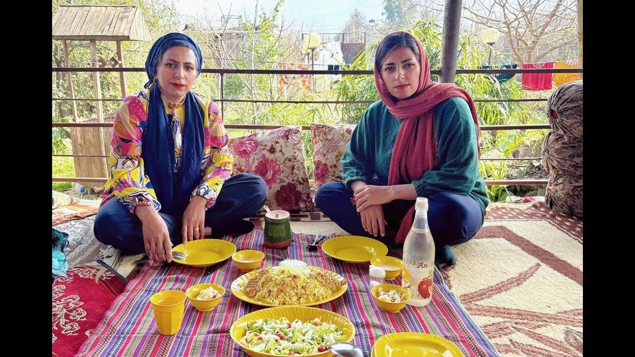 Rural life in Iran;cooking carrot rice over a fire