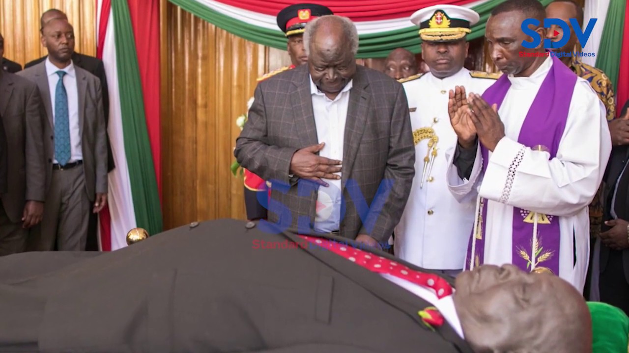 Former President Mwai Kibaki views Mzee Moi's body in Parliament