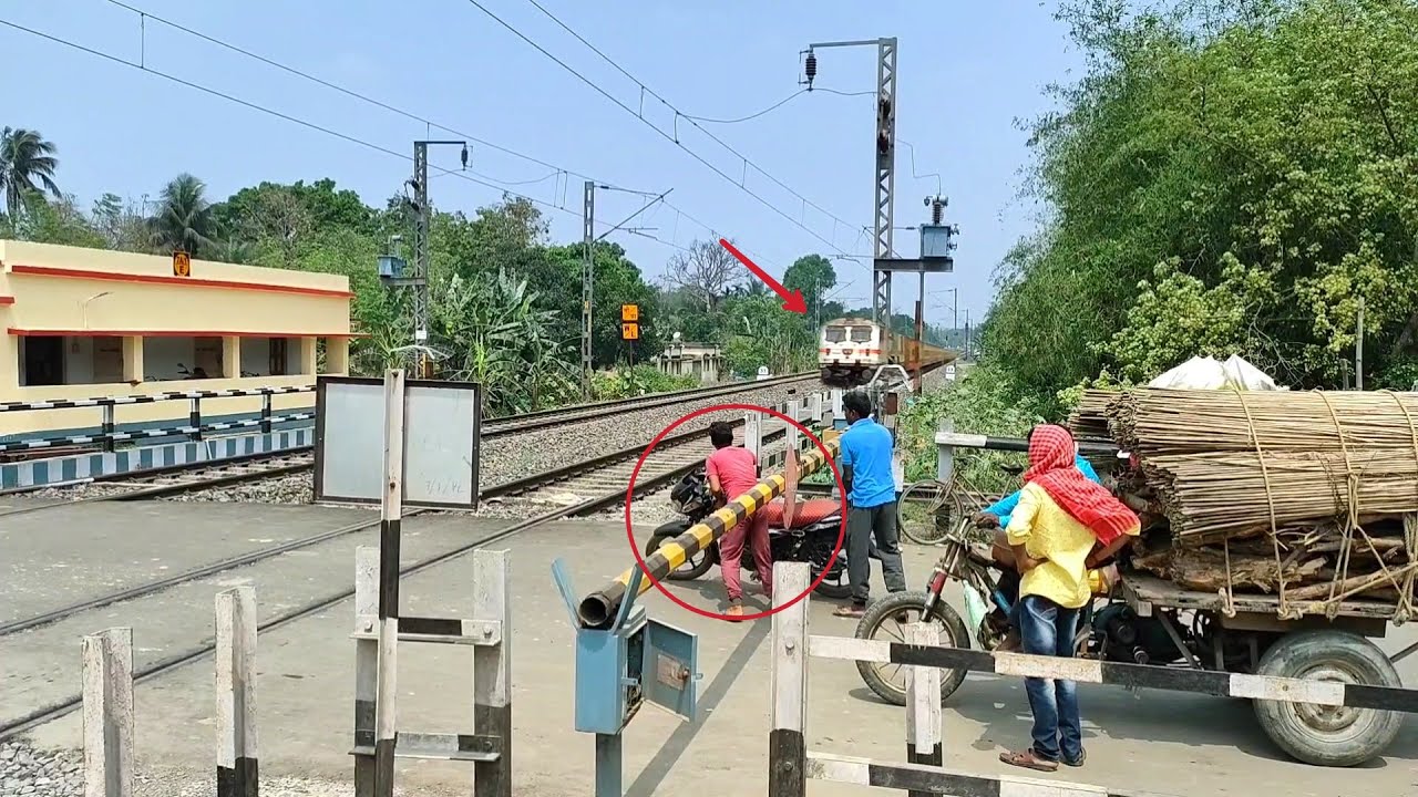 Bike Passing Under Railgate : gateman Loud Shouting Trains Dangerous Speedy Moving Level Crossing