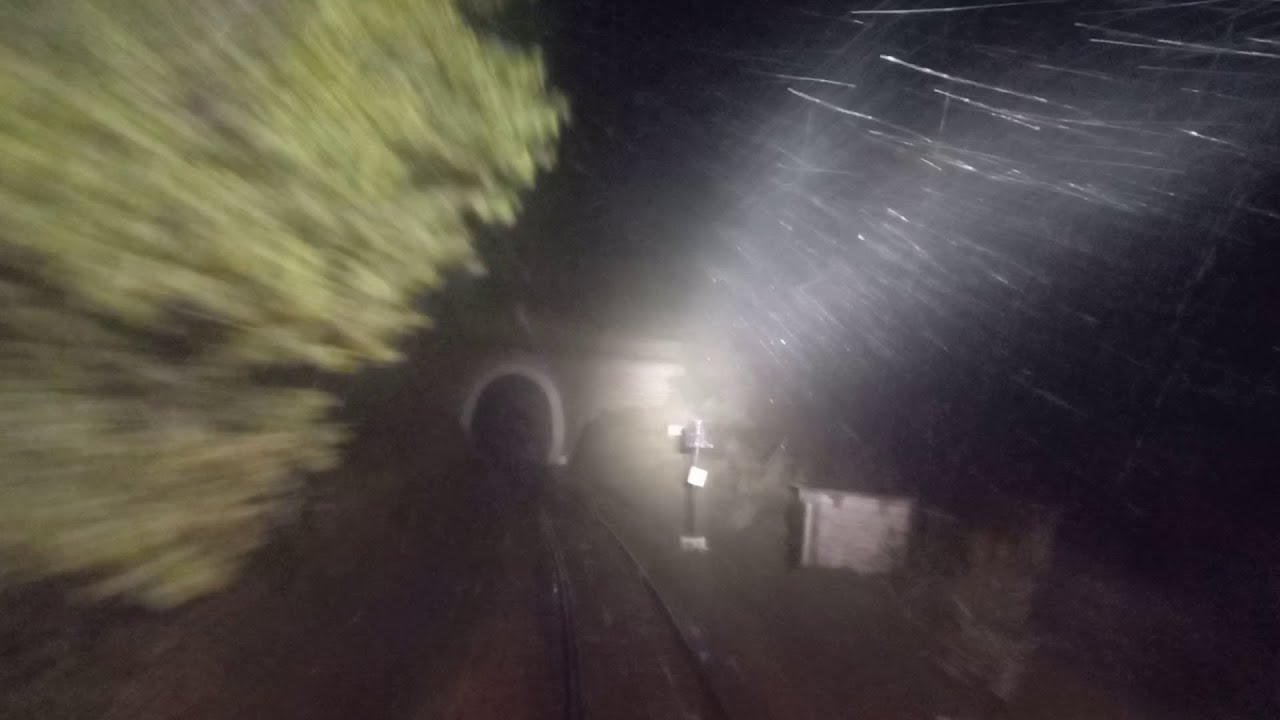 Live scary view from train driver cab at night Heavy raining lightning and thunderstorm in mountains