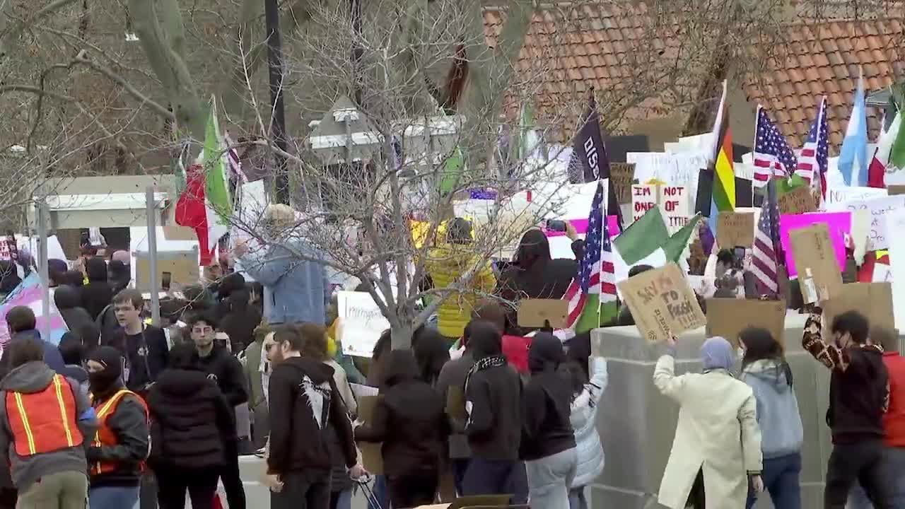 Demonstrators march through downtown Salt Lake to protest President Trump's policies