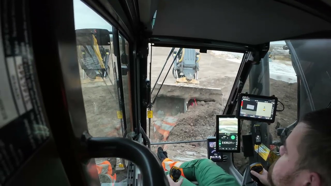 Volvo EC300FL cutting a drain ditch in topsoil