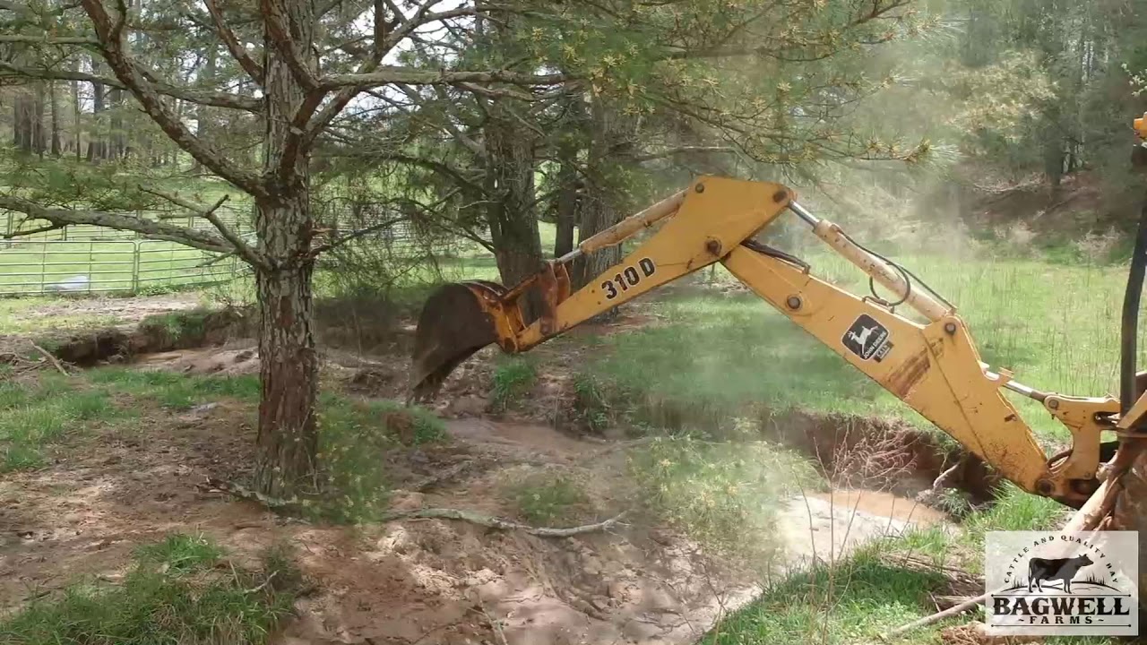 Digging out a culvert with the 310 Deere