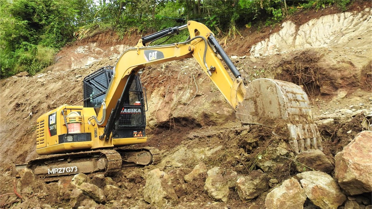 Mini Excavator CAT 307E Cutting The Slope