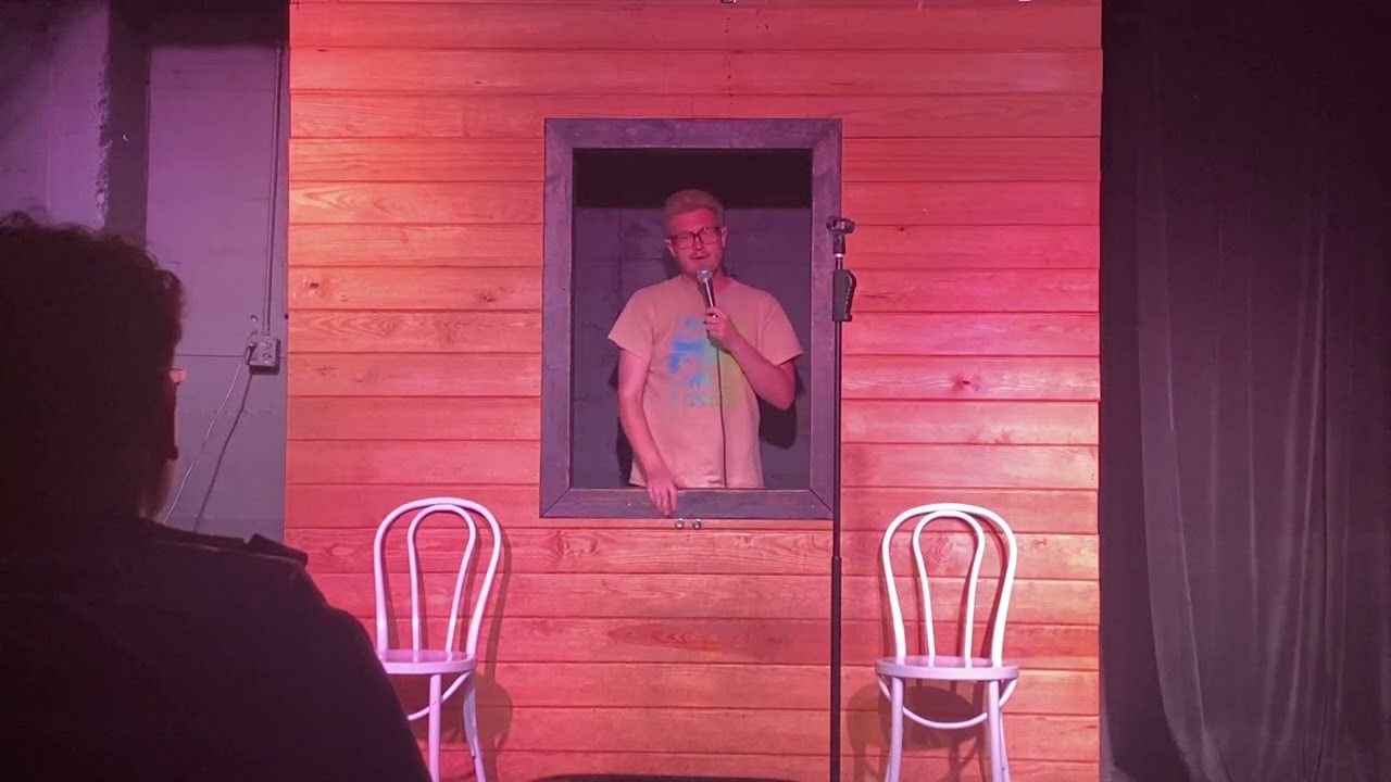 goofy comedian does set at Austin black box theater open mic for small audience - Derek Dimpfl