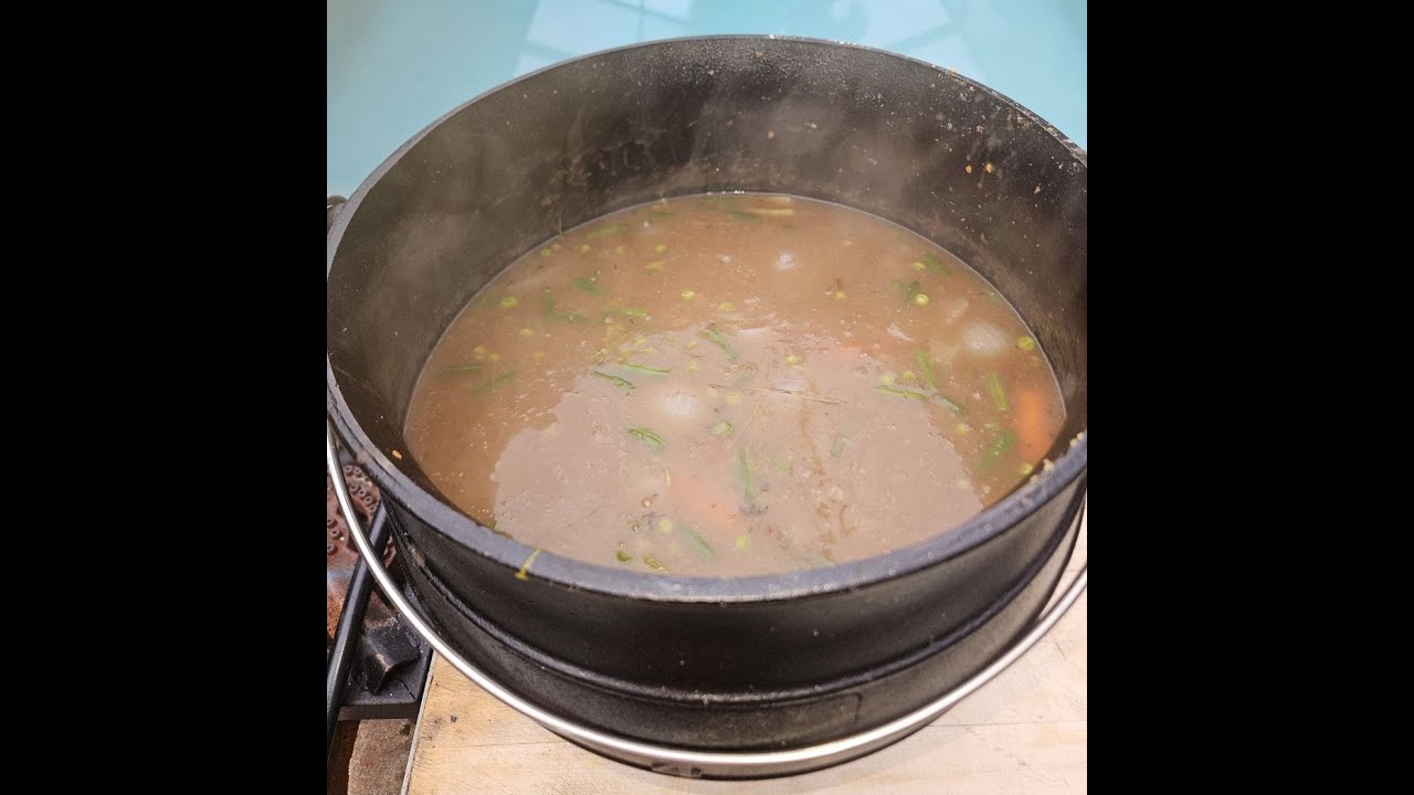 Beef Stew In Cast Iron Cauldron In Hot Coals.