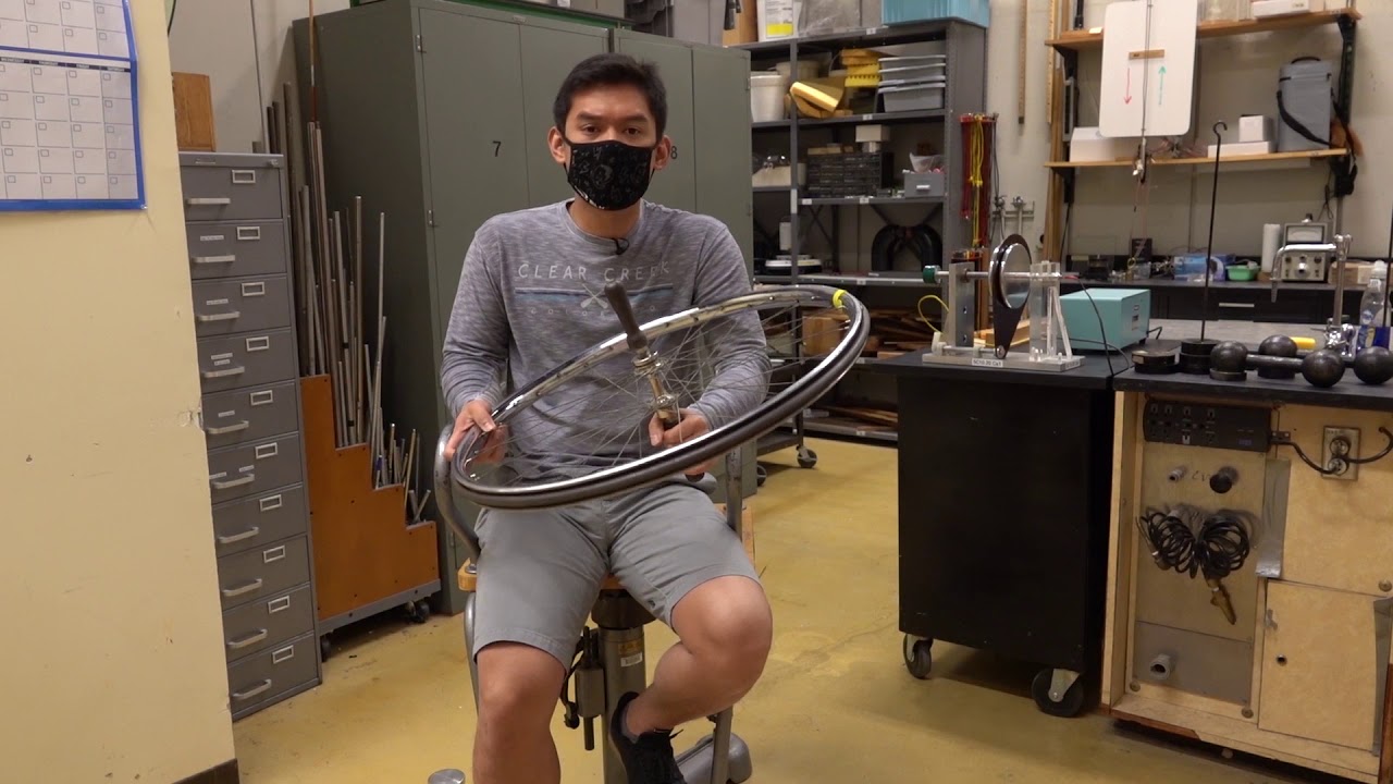 Angular Momentum Conservation with A Spinning Wheel