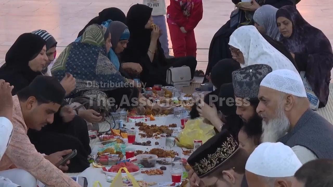 Iraqis break their fast at mosque in Baghdad on first day of Ramadan
