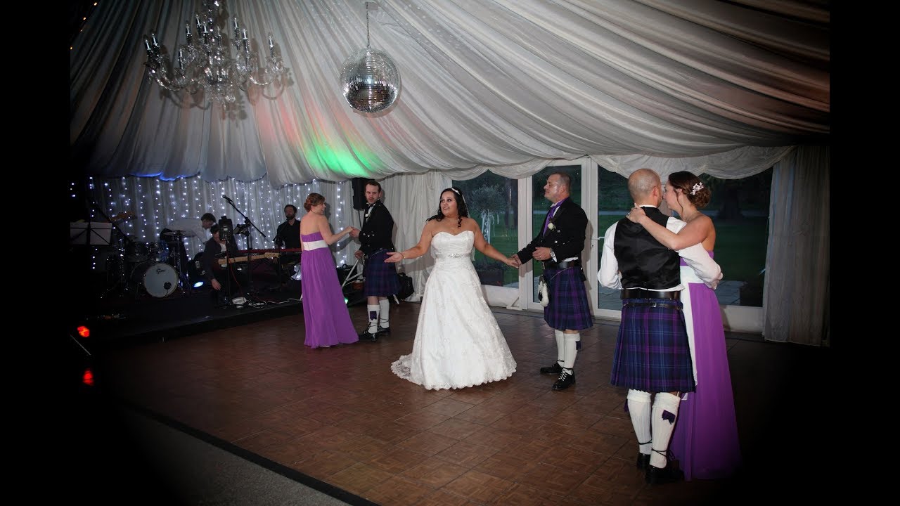 Scottish Pipe Band gate crashes wedding. Bag Pipes, drums, traditional Scottish music.