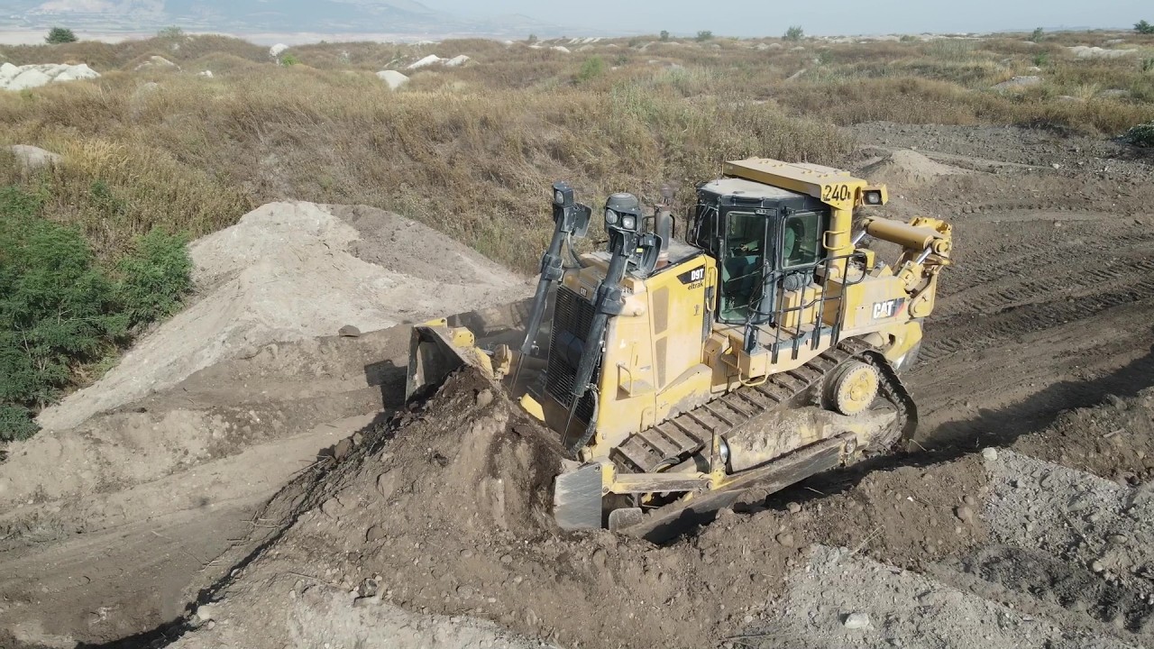 Caterpillar D9T And Komatsu D275AX Bulldozers Rehabilitating An Old Mining Area