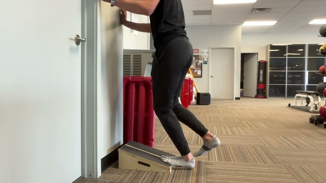 Single leg slant board heel raise (knee bent)