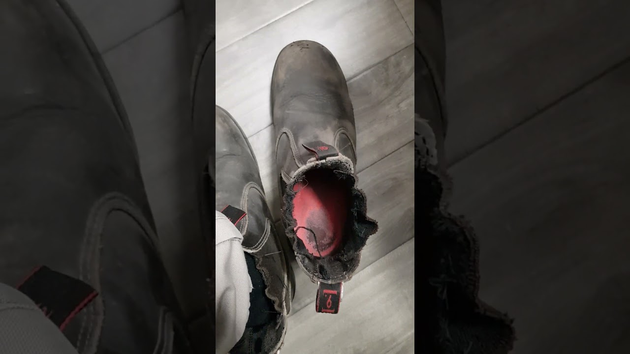tradie taking off steel capped workboots and putting it back on again - redback workboots