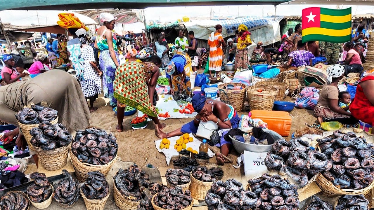 Seaside market day in Aflao Togo Ghana border . Buying coconut oil and dry fish in Bulk.