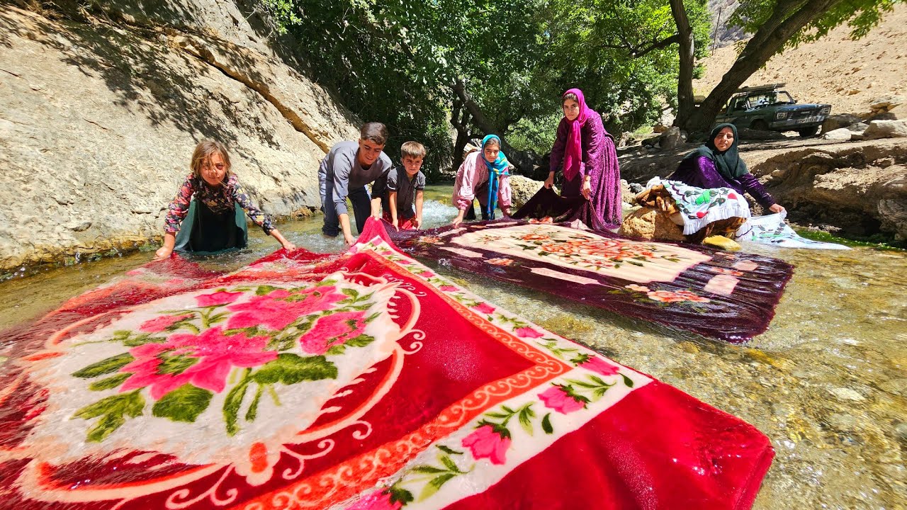 Washing blankets in raging water by a nomadic family 🌊🛏️👨‍👩‍👧‍👦
