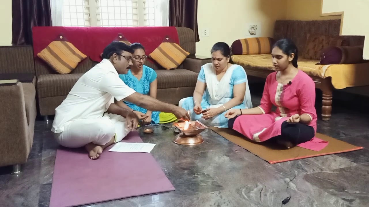 Performing Agnihotra with family.