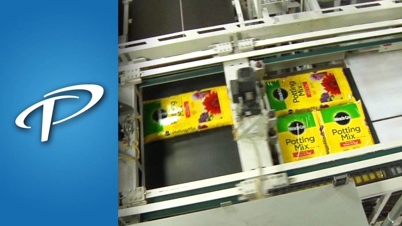 Bag Palletizer stacking bags of potting soil (APH-1240, Formerly AP-440 Series)