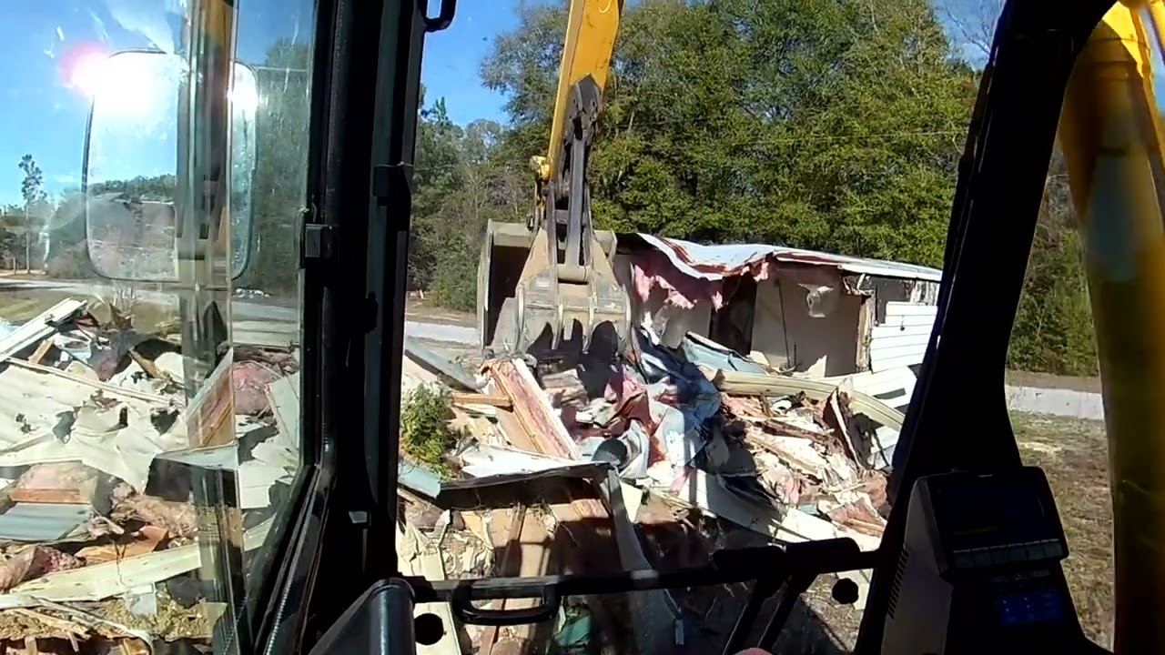 Excavator Tearing Down A Mobile Home PC 210