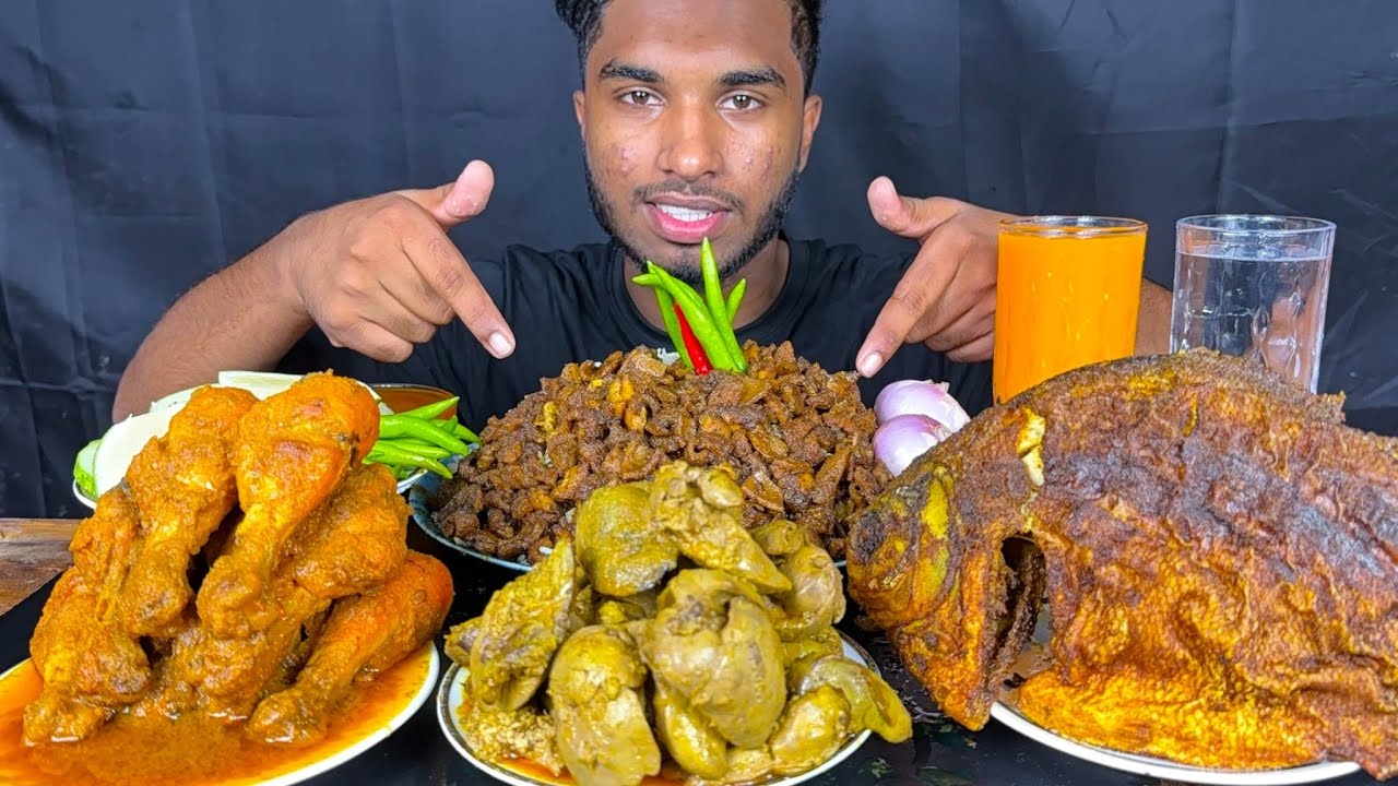 spicy chicken leg piece curry, full fish fry, chicken liver curry and goat boti with rice eating