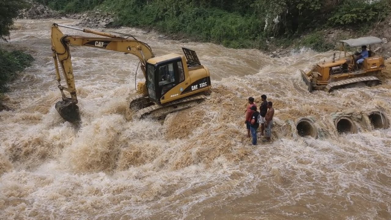 Small Bulldozer and Excavator Pushing Soil Built a Bridge Across water