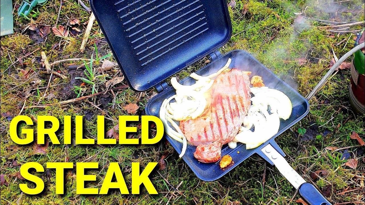 Cooking a steak breakfast in the woods. Gas stove cooking